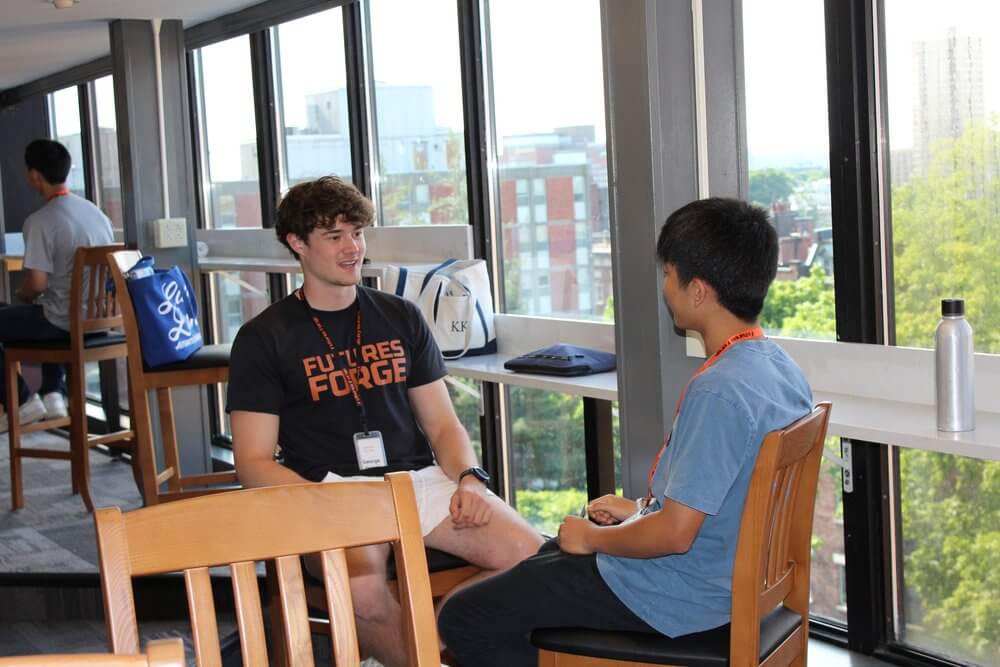 Two students engage in a conversation during the Futures Forge summer program for high schoolers.