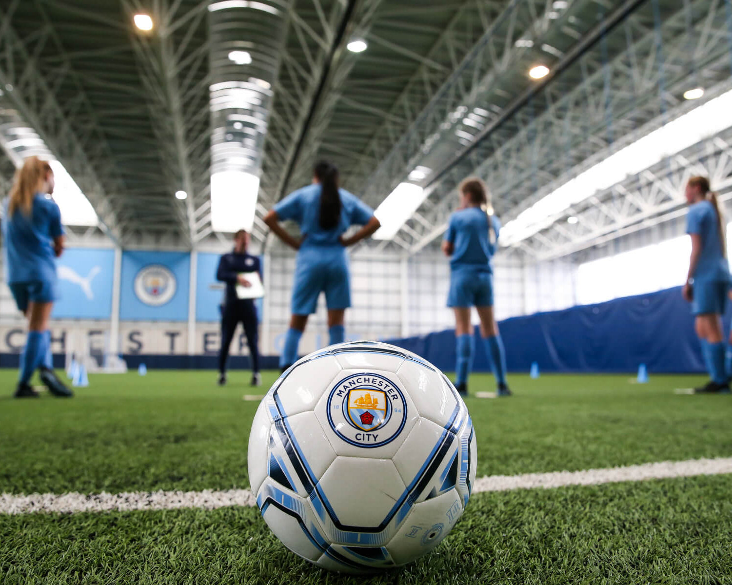 Manchester City soccer ball with players in training during an elite summer camp.