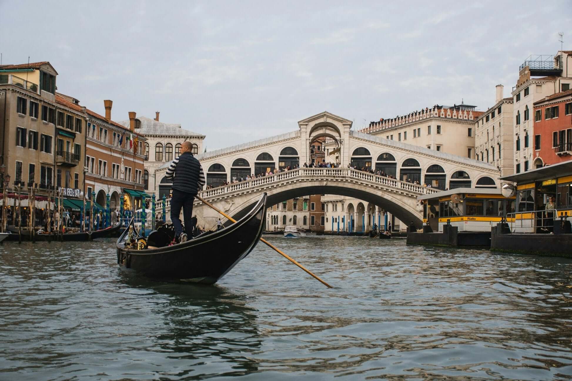 Gondola ride on the Grand Canal near Rialto Bridge in Venice, showcasing a unique student travel experience.