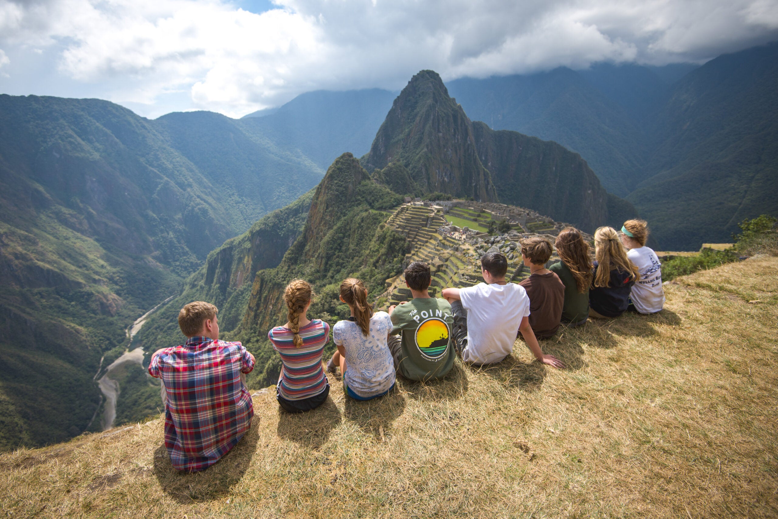 Group of high school students enjoying the view of Machu Picchu during a summer travel program.