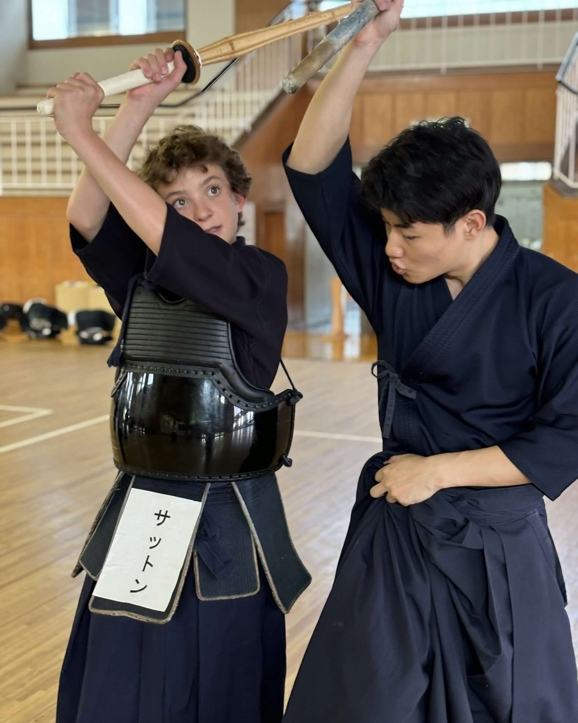 High school students engage in a kendo practice session, showcasing teen travel in Japan's cultural experiences.