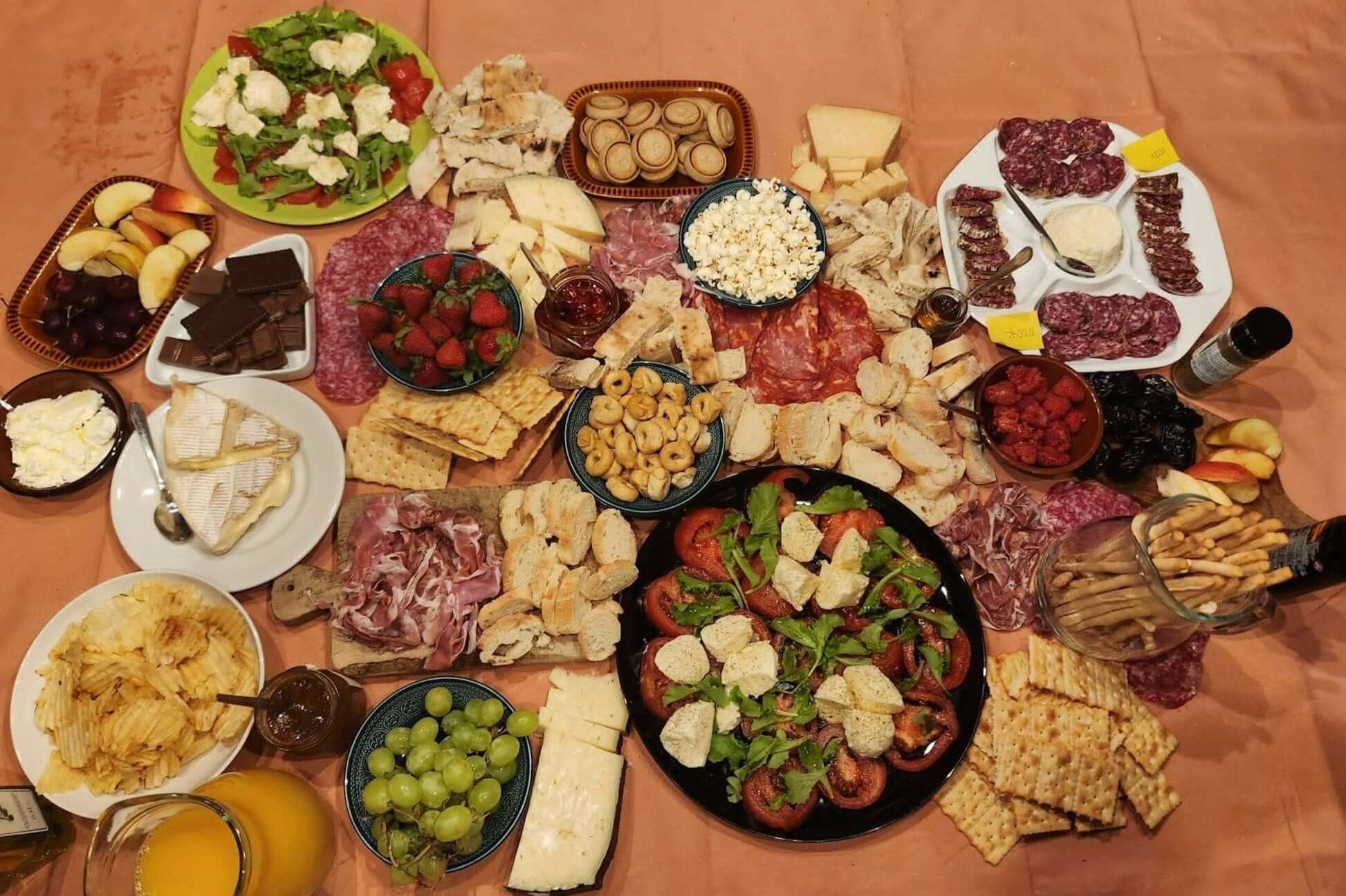 A vibrant spread of Italian delicacies including meats, cheeses, fruits, and snacks perfect for a Northern Italy adventure.