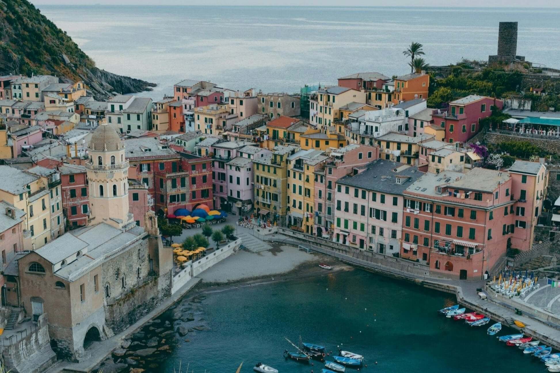 Colorful coastal village in Cinque Terre, Italy, showcasing picturesque buildings and tranquil waters. Ideal for teen travel.