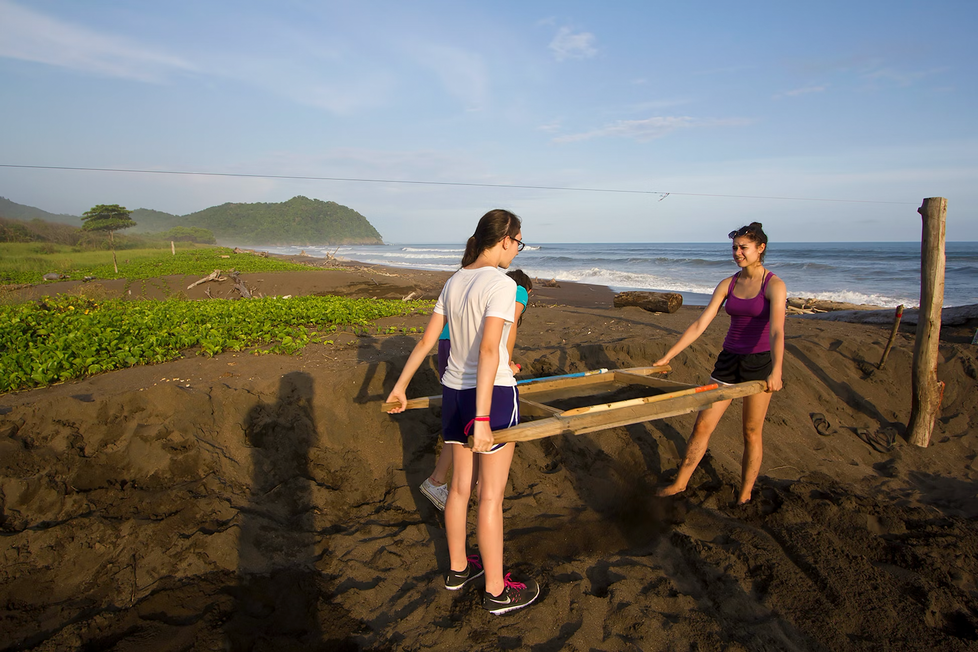 High school students participating in Costa Rica Turtle Conservation Project, working on beach conservation efforts.