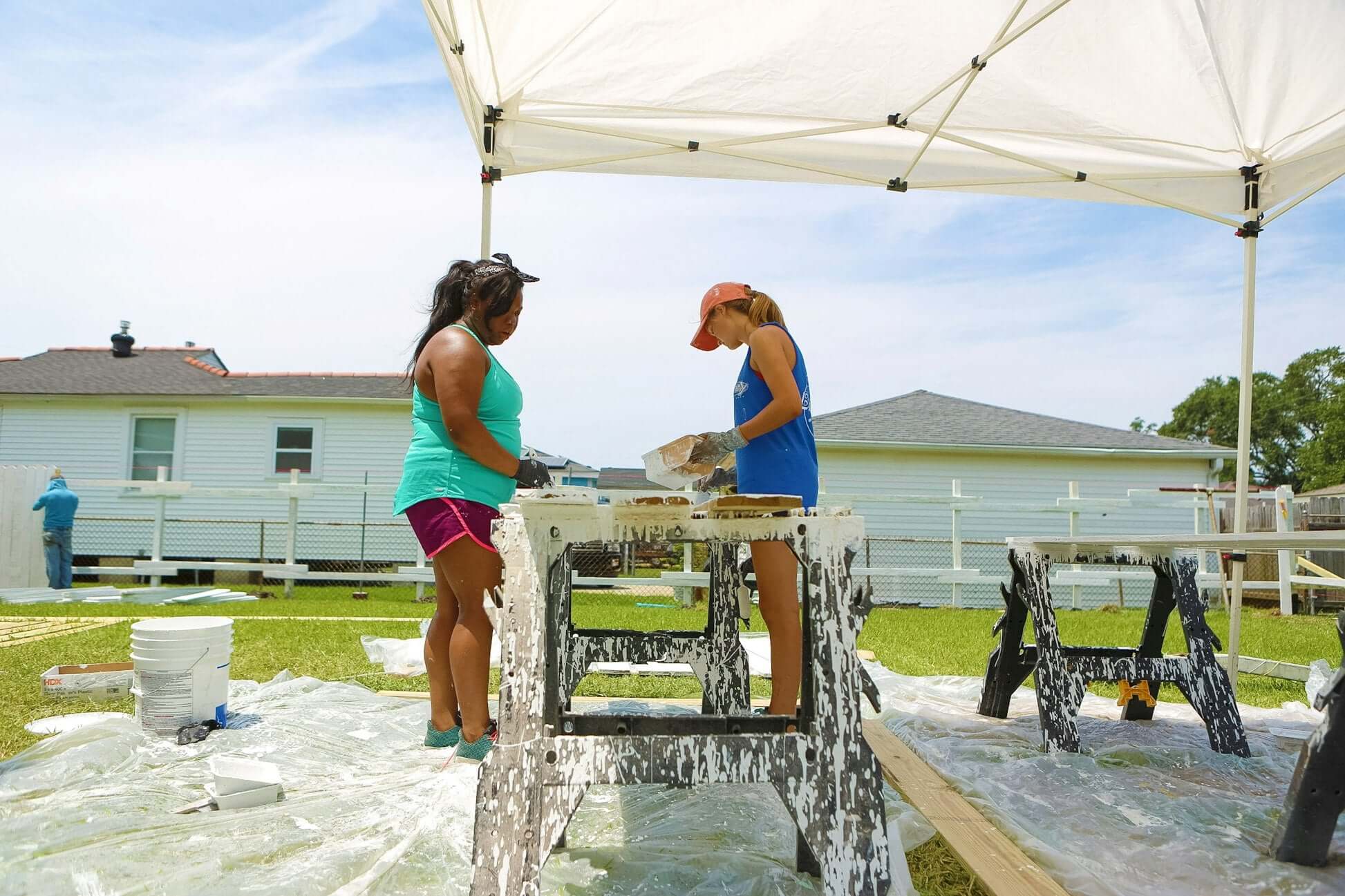 Two high school students working together on a rebuilding project in New Orleans, focused on community initiatives.