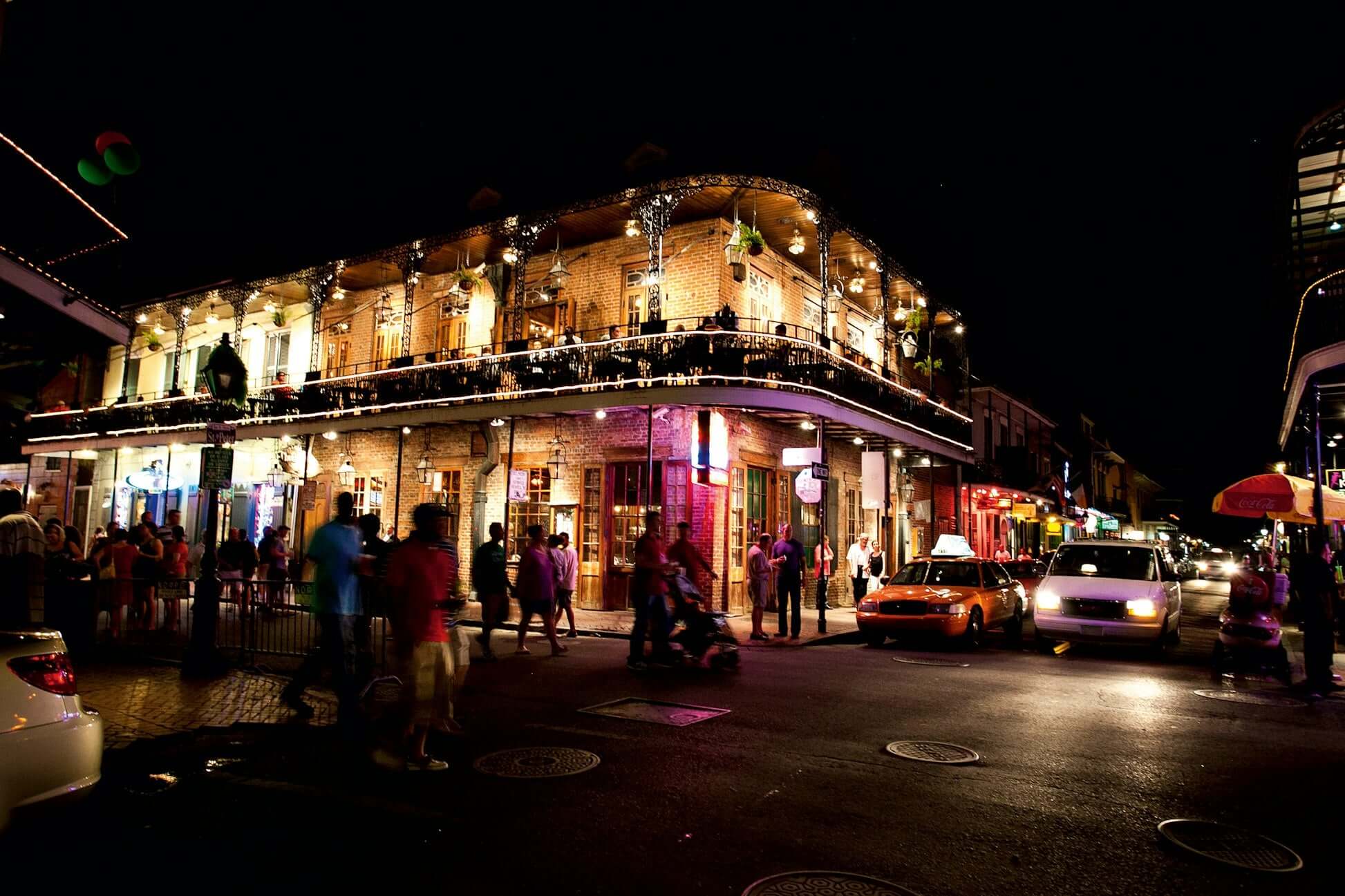 Vibrant nightlife in the French Quarter, New Orleans, showcasing lively streets and historic architecture.