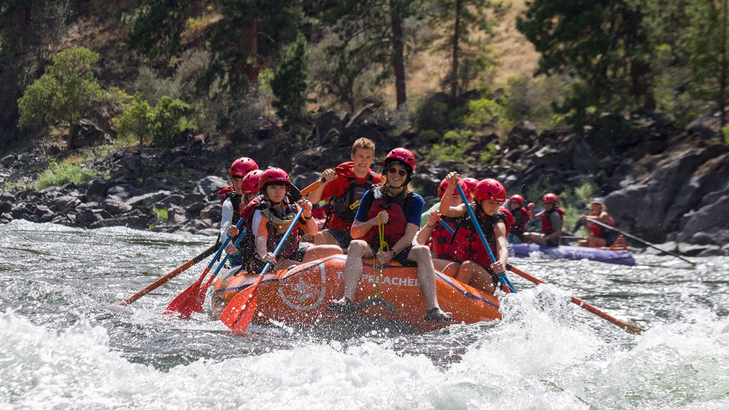 Teens enjoying a thrilling rafting adventure at a summer camp, promoting teamwork and outdoor fun.