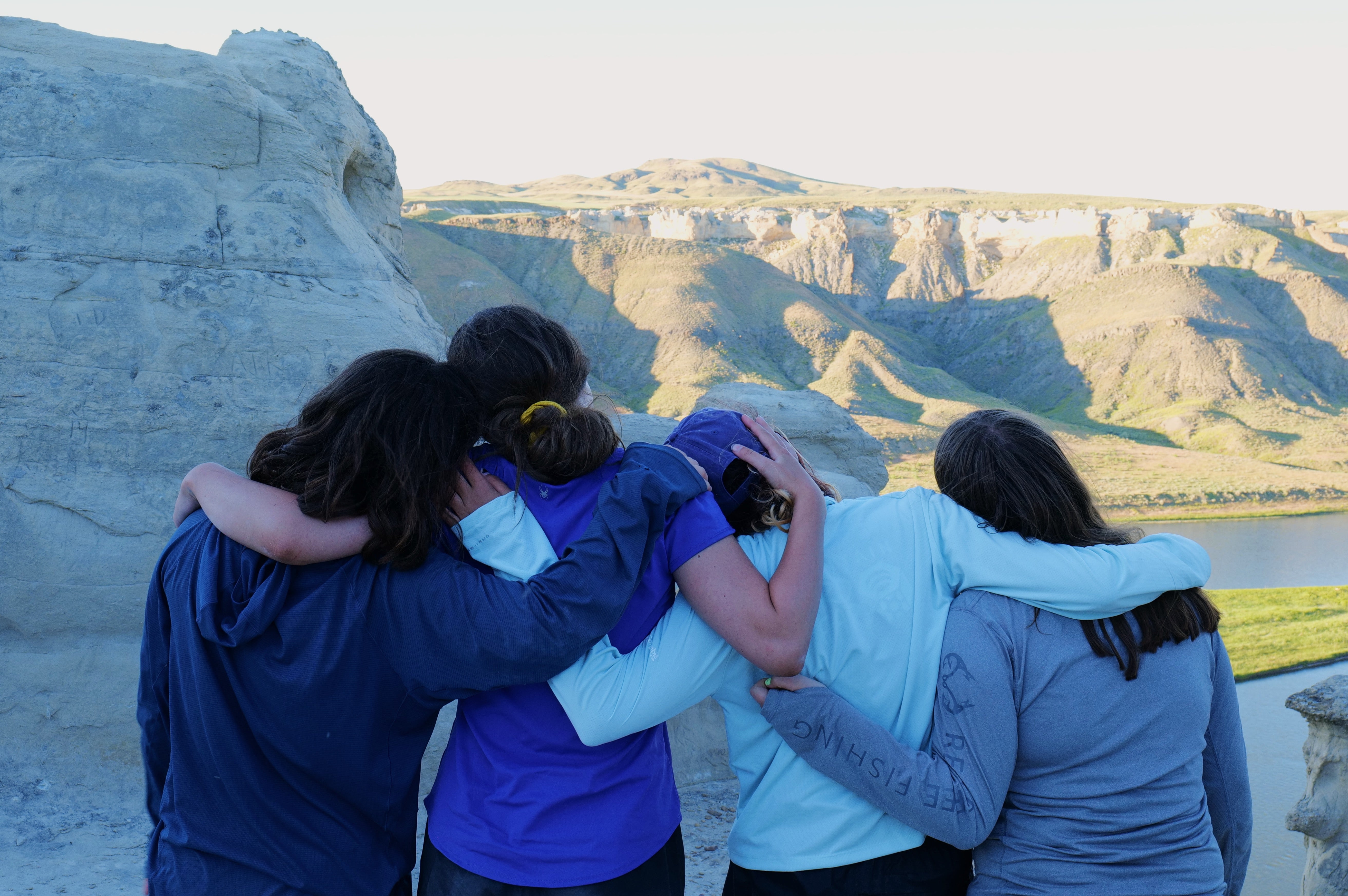 Group of teens enjoying nature at Alpengirl Camp, embracing the scenic beauty of the outdoors during summer adventure.