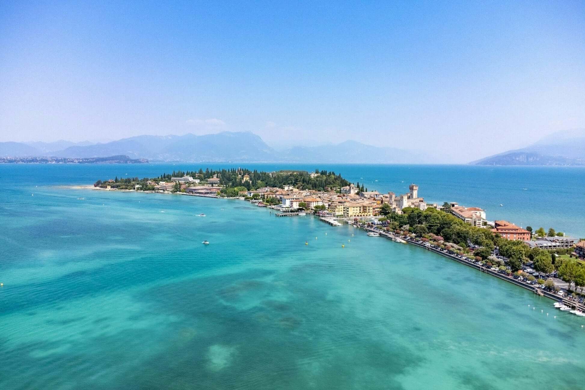 Aerial view of a picturesque Italian coastal village on Lake Garda, perfect for student travel adventures in Northern Italy.