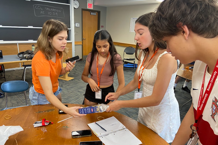 High school students collaborating on a project in a summer program, enhancing skills for future success.