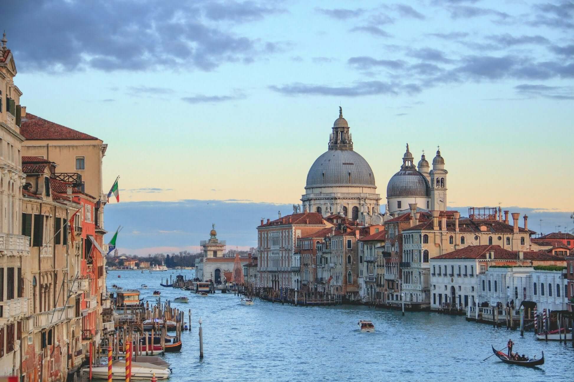 Scenic view of Venice with grand domes and a tranquil canal, perfect for student travel adventures in Northern Italy.