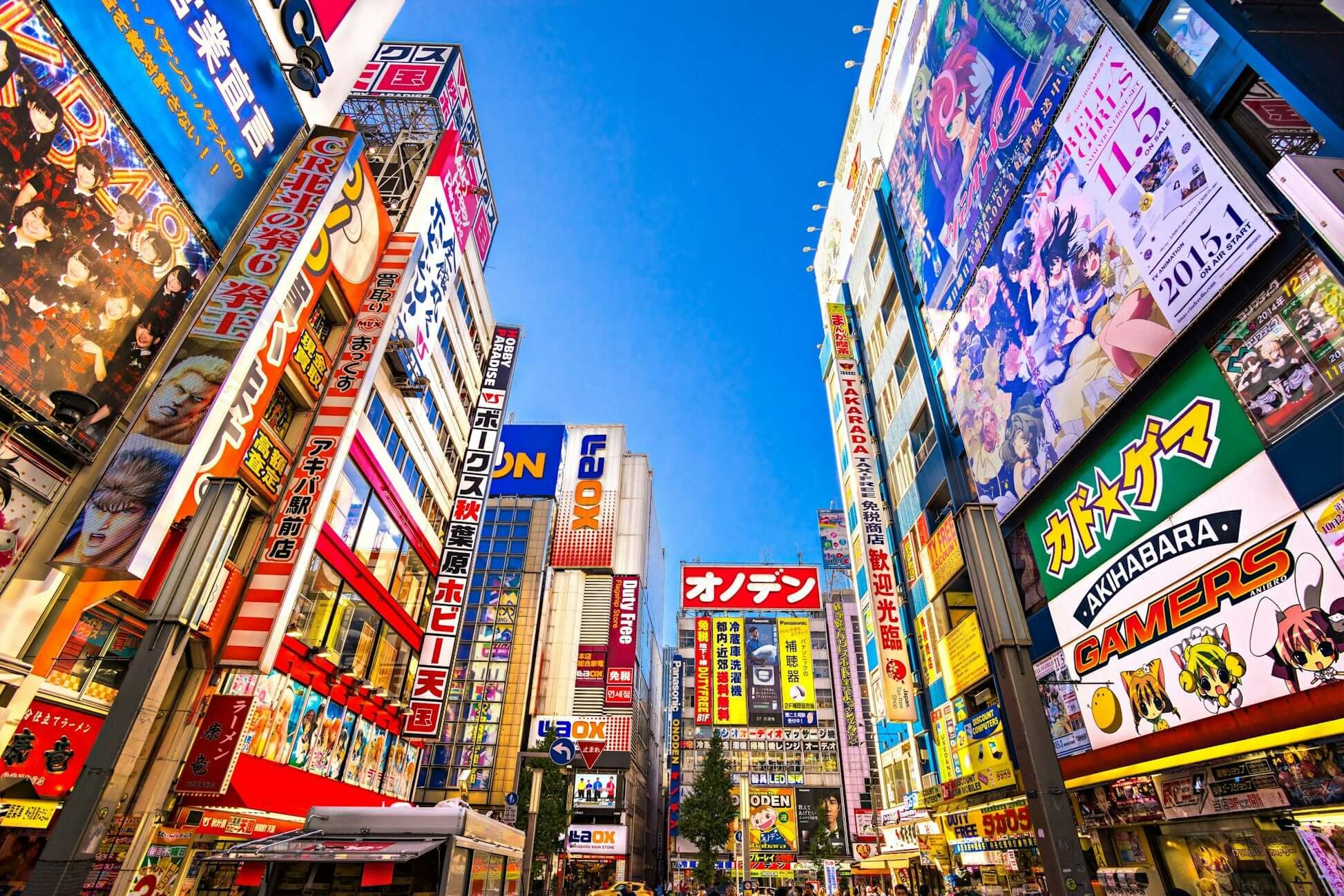 Vibrant streets of Tokyo showcasing neon lights and colorful advertisements, ideal for summer programs for high school students.